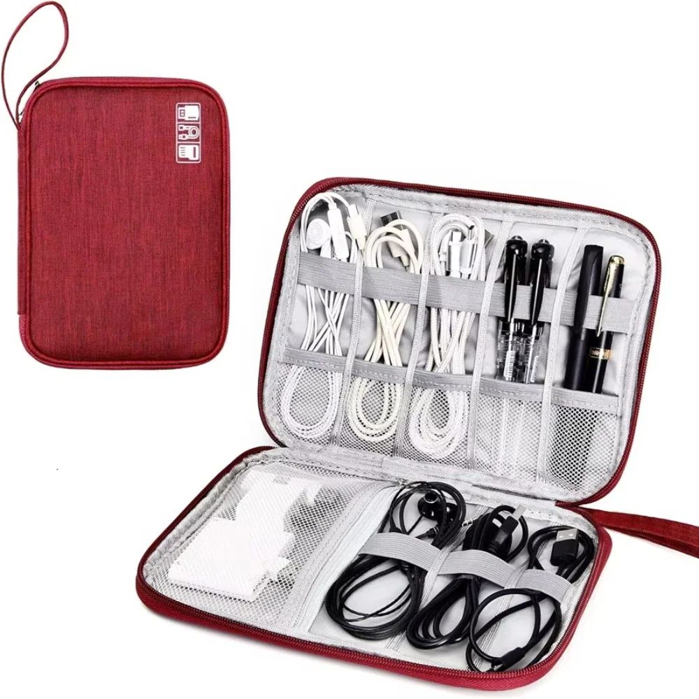 Red travel organizer with electronic cables and devices inside on a white background